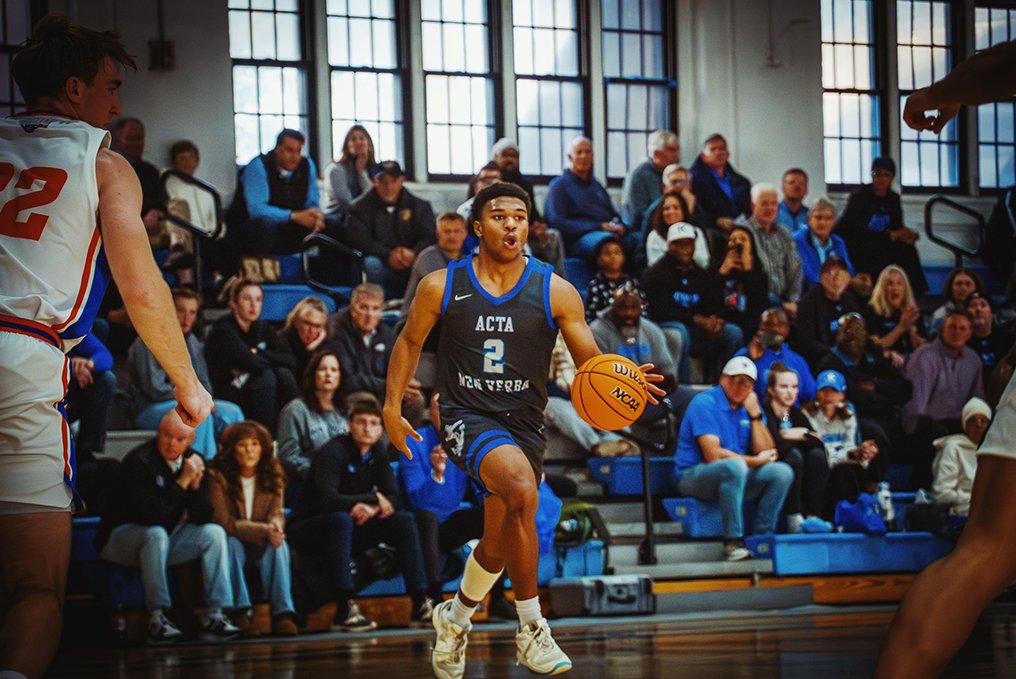 Student expertly dribbles basketball between opponents.