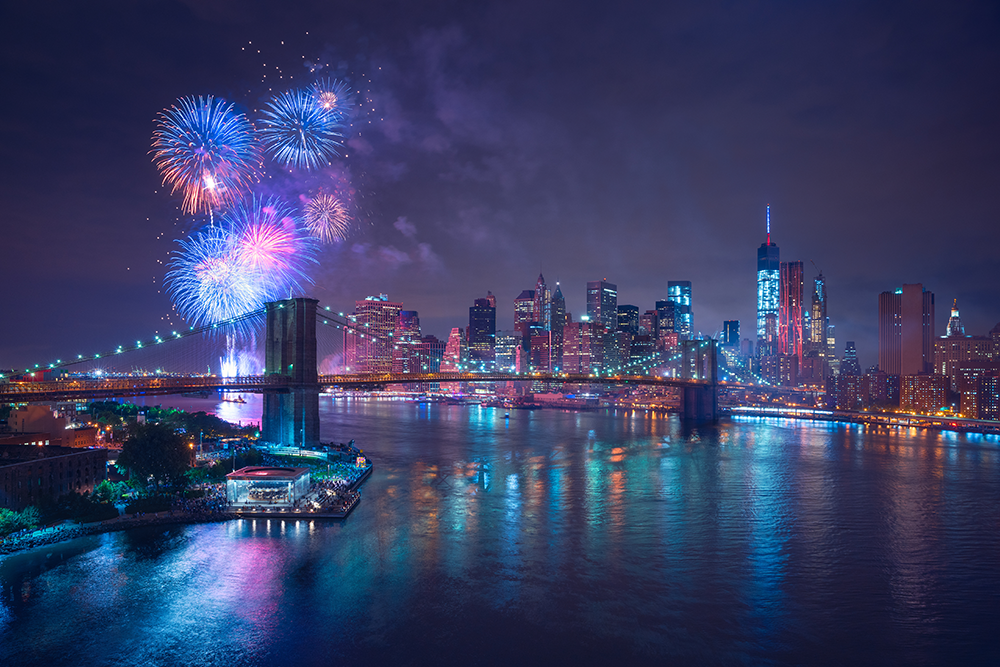 Multicolor fireworks exploding over New York City at night.