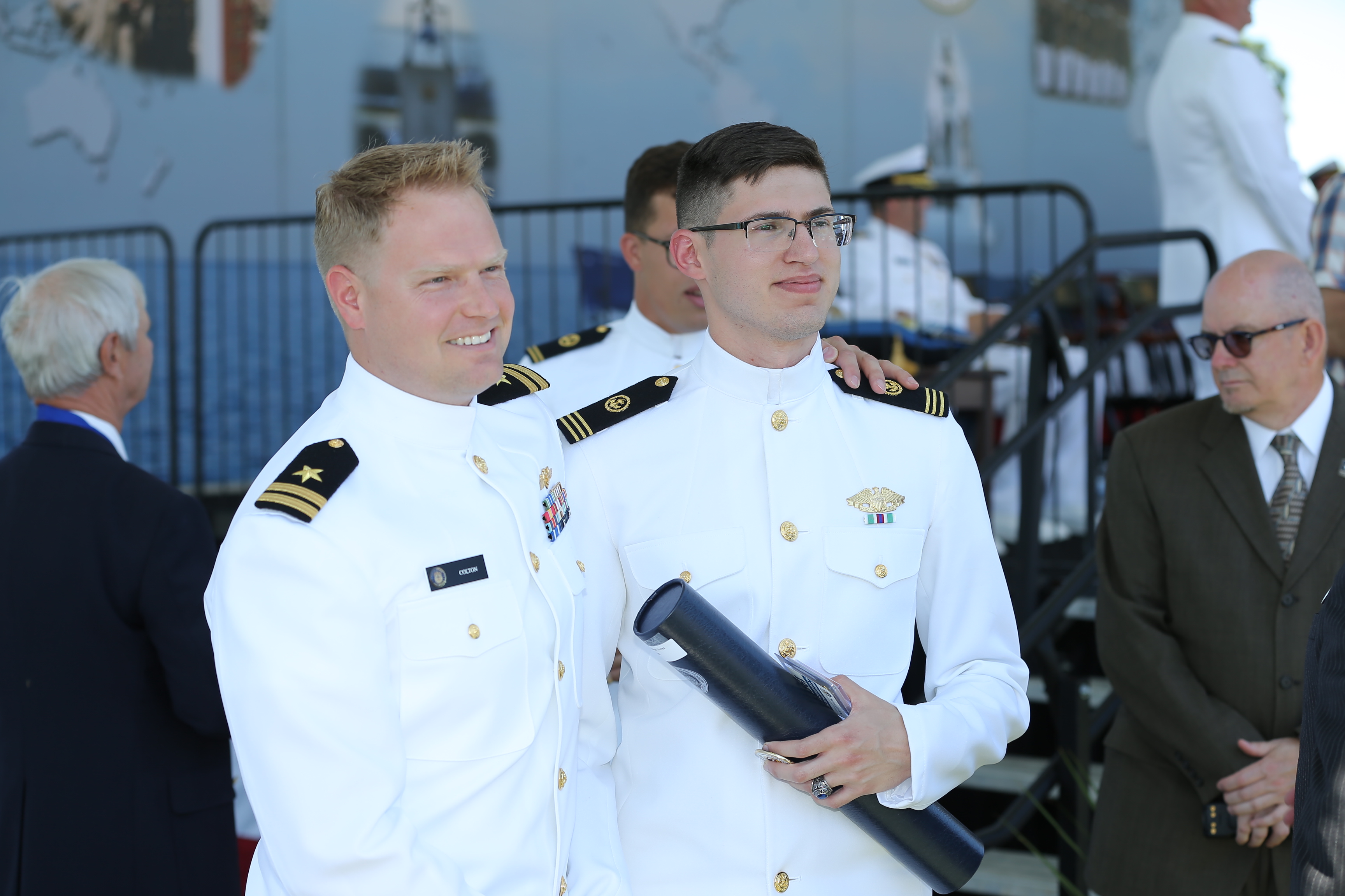 LT Casey Colton, '14 congratulates Ensign Ryan Torres