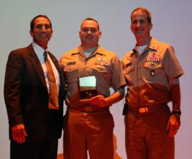 Deputy Maritime Administrator Mike Rodriguez ’79, and USMMA Superintendent Rear Adm. James A. Helis, USMS, present Lt. Cmdr. Paul Acquaro the Maritime Administration’s Employee of the Quarter award. Deputy Maritime Administrator Mike Rodriguez ’79, and USMMA Superintendent Rear Adm. James A. Helis, USMS, present Lt. Cmdr. Pau